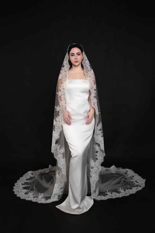 Front view of The Heirloom single tier lace cathedral veil, wide scalloped lace border spreading across the floor