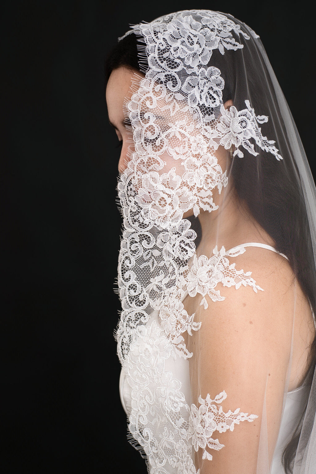 Close detail of the wide scalloped lace border on The Heirloom cathedral veil, showing the floral lace pattern
