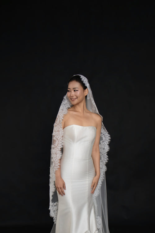 Front view of The Close Up cathedral length mantilla with lace edging the full perimeter of the veil