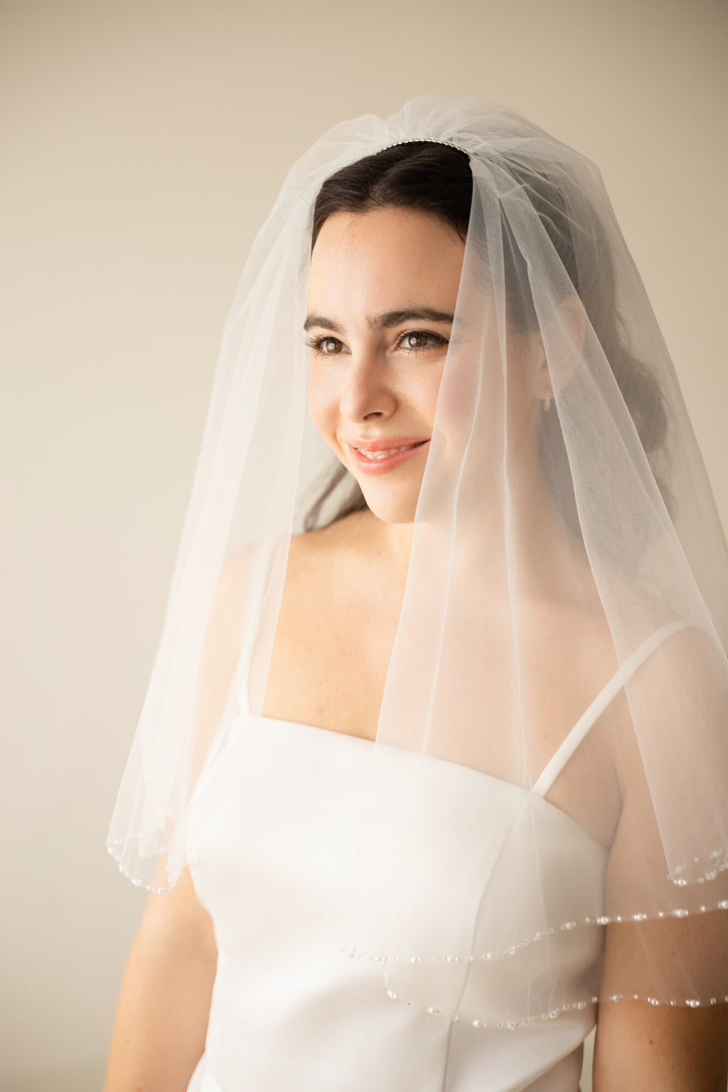 The Second Look blusher worn forward over the face, with the beaded pearl border resting at the neckline