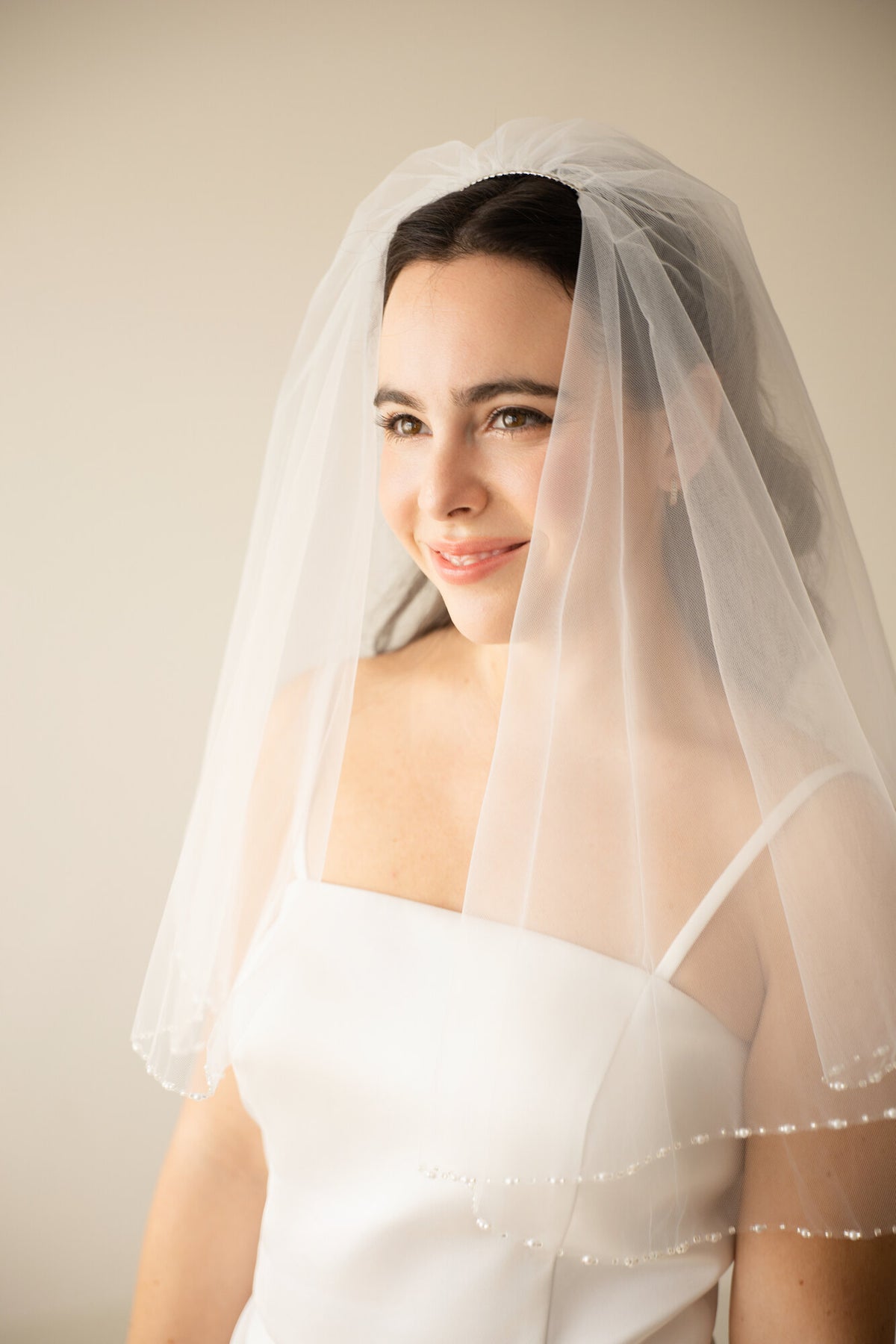 The Second Look blusher worn forward over the face, with the beaded pearl border resting at the neckline