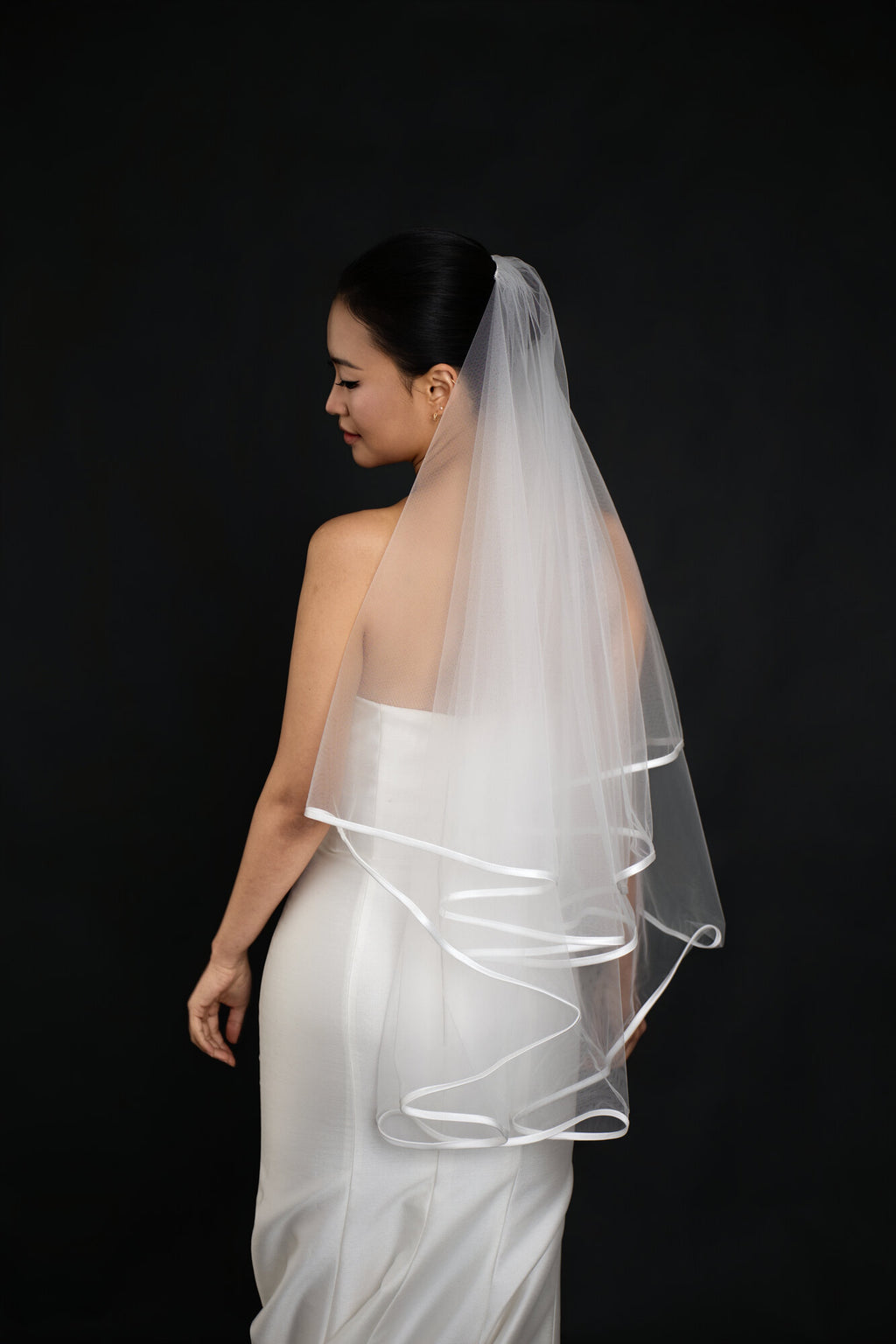 Side and back view of The Clean Line two tier veil showing how the satin ribbon edge traces the outline of both layers